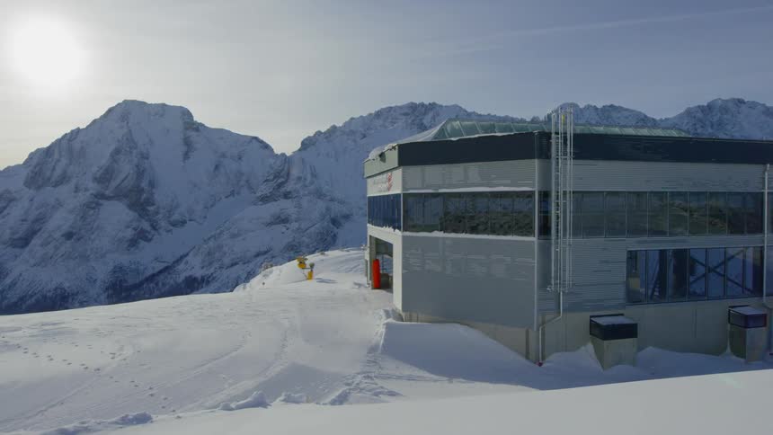 Ski lift building on top of snow covered mountain