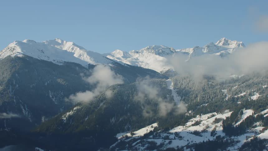 The clouds cover the hills near the mountain