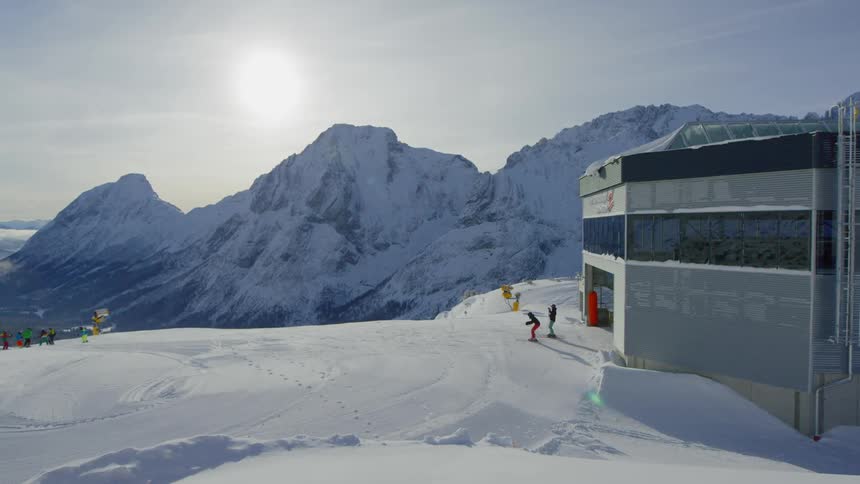 People exit a building to go on the ski slope
