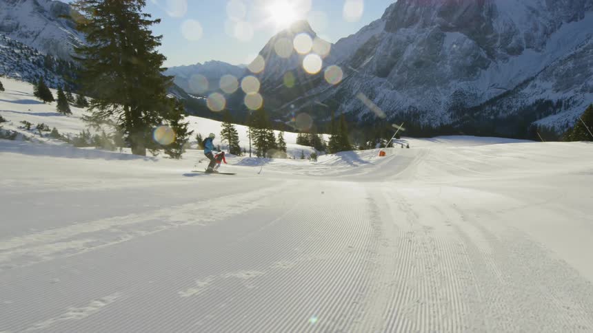 People are skiing down a hill in winter