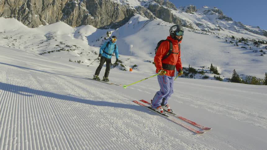 Skiers going down a gentle slope covered in snow