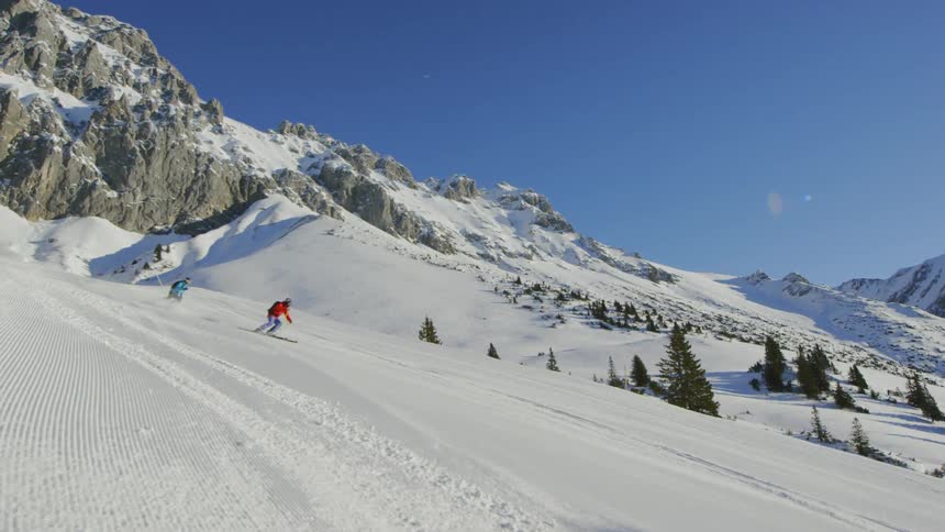 People snow boarding on the snowy mountain