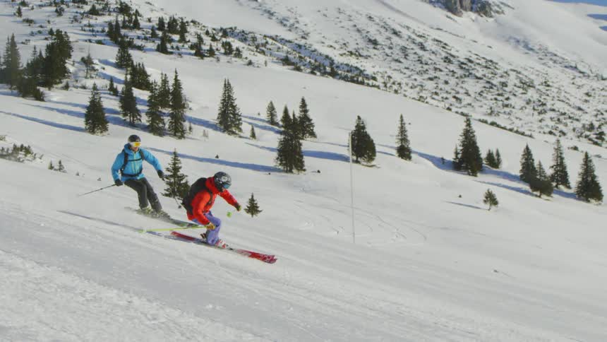 People playing snowboard at the snowy mountain