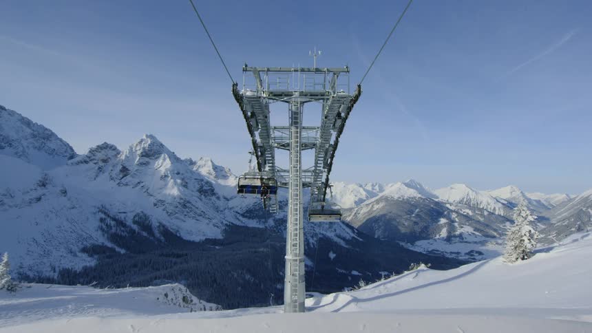 The ski lifts carry people over the slope