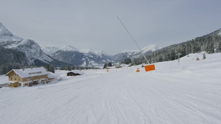 Snow covers a ski resort set amongst mountains