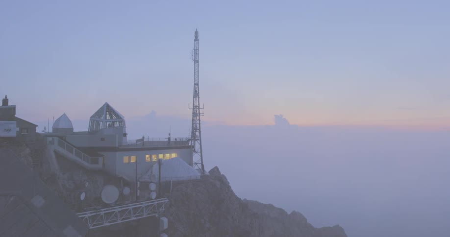 A scenery of a building on the mountain peak