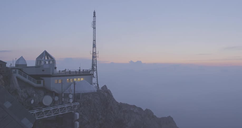 A scenery of a building on top of a mountain