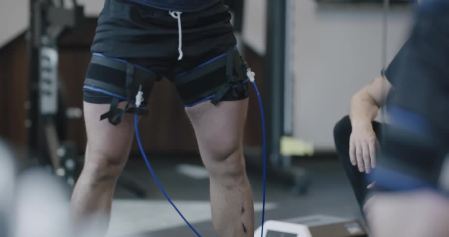 A man does squats in the gym