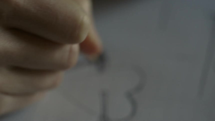Someone drawing a heart with a pencil
