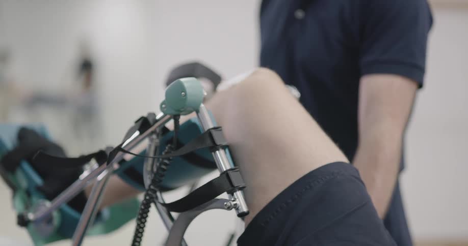 A doctor is helping a patient with their leg