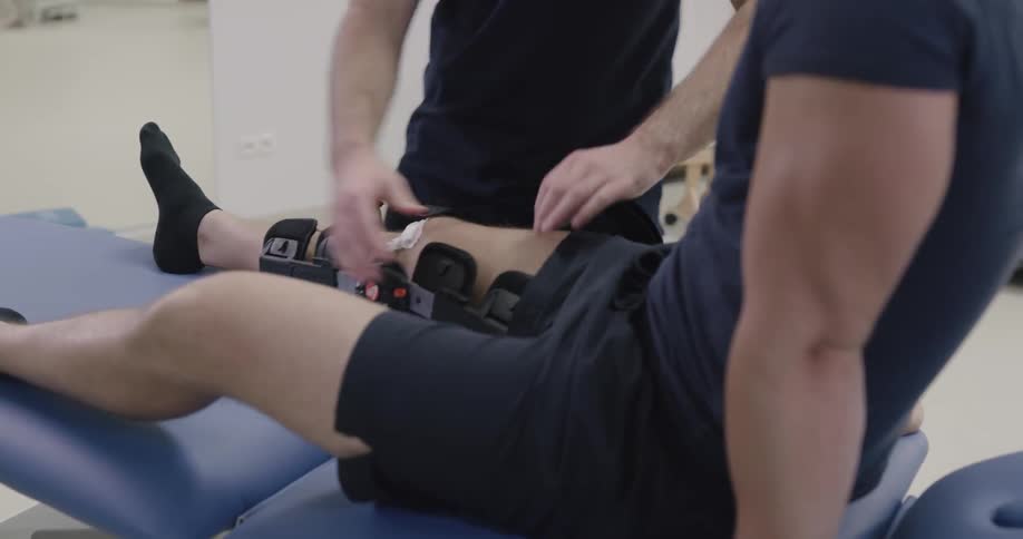 A male doctor release a brace from a patient leg