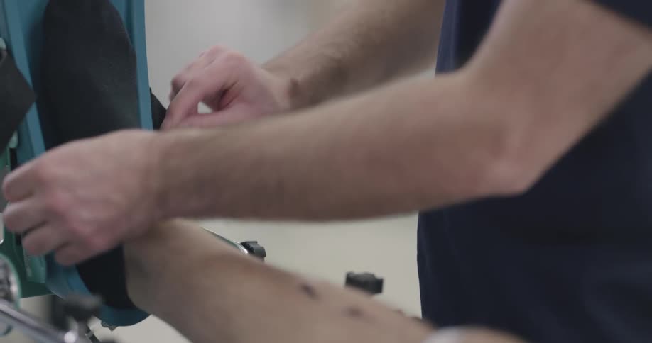 Man fastening the strap on the patient foot