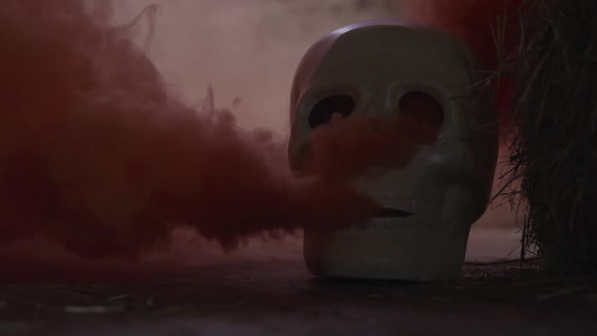 A skull pours red smoke out of its orifices