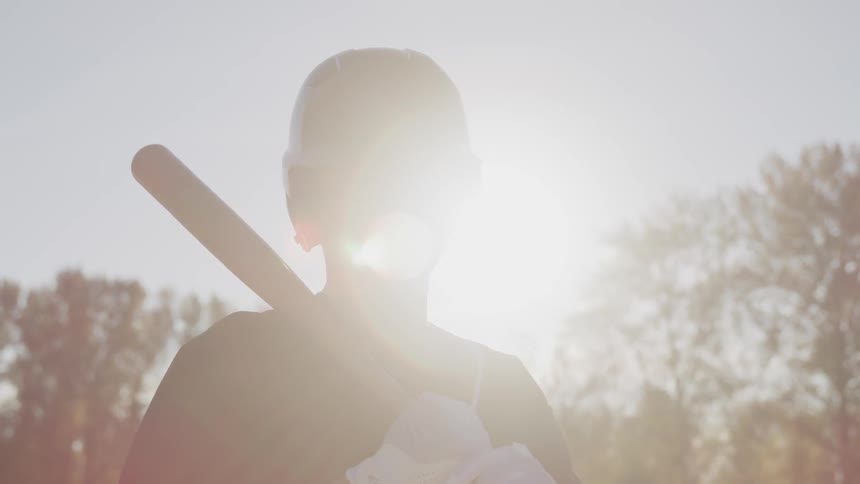 A portrait of a young man with a baseball bat