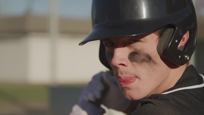 A portrait of a man waiting to hit a baseball
