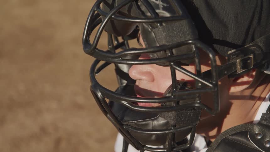 A catcher has his mask and padding on