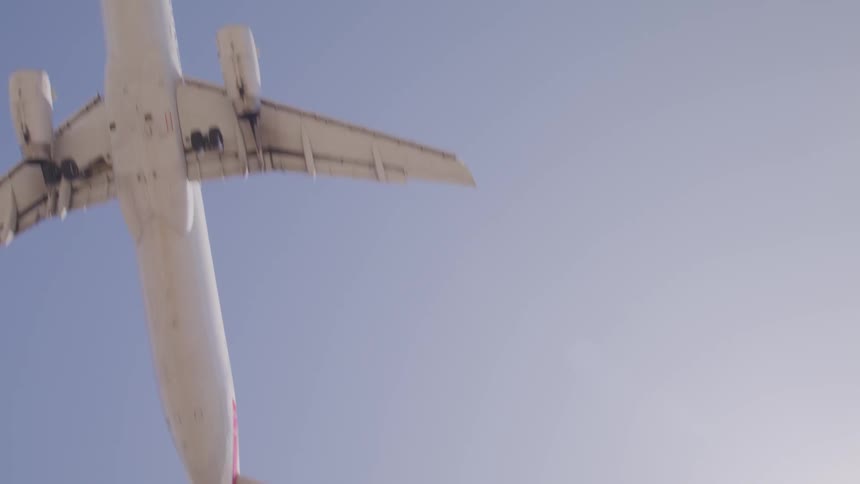 Close up of commercial passenger airplane flying overhead
