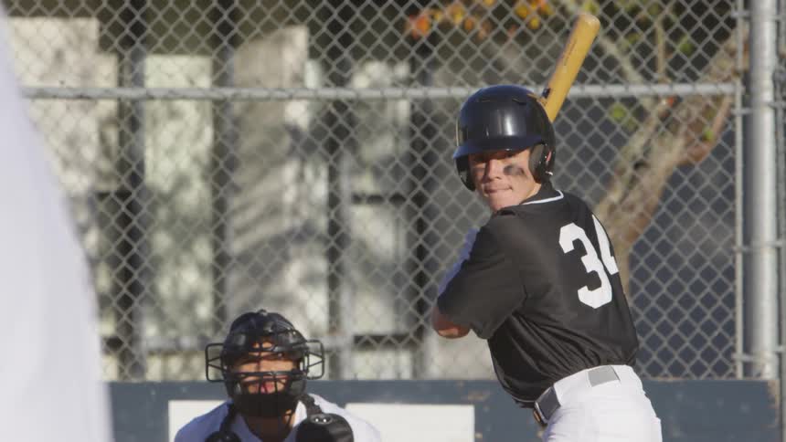 A batter watching for and then hitting a baseball pitch