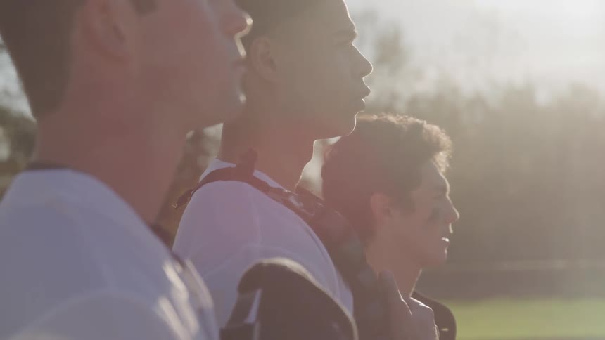 A group of man facing towards the sun
