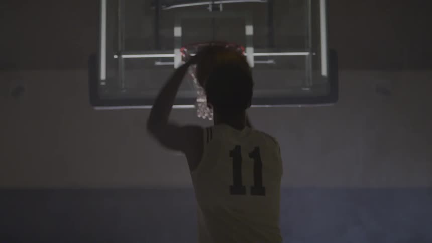 A man shoots the basketball
