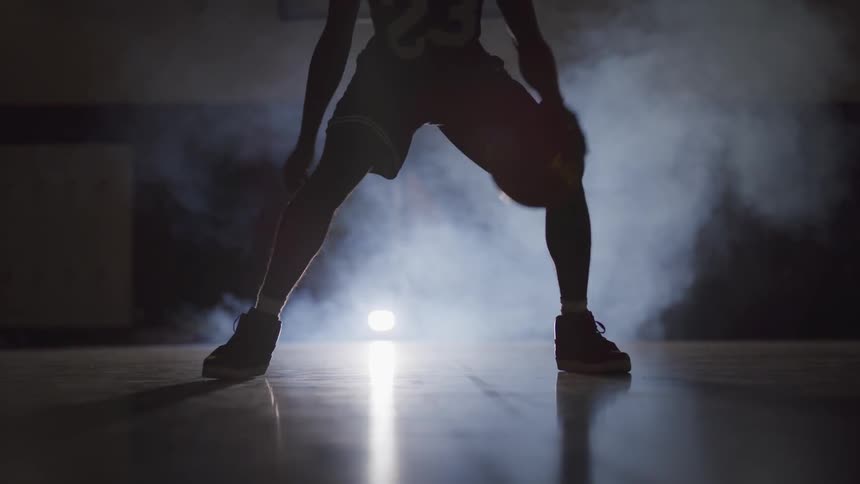 A man dribbles the ball