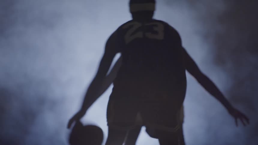 Two men playing basketball in heavy fog