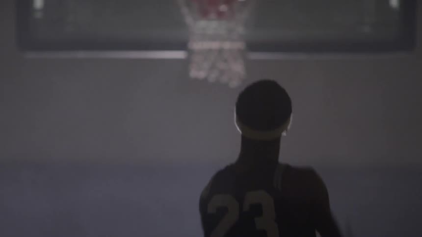 Black man shoots a basket in the basketball court