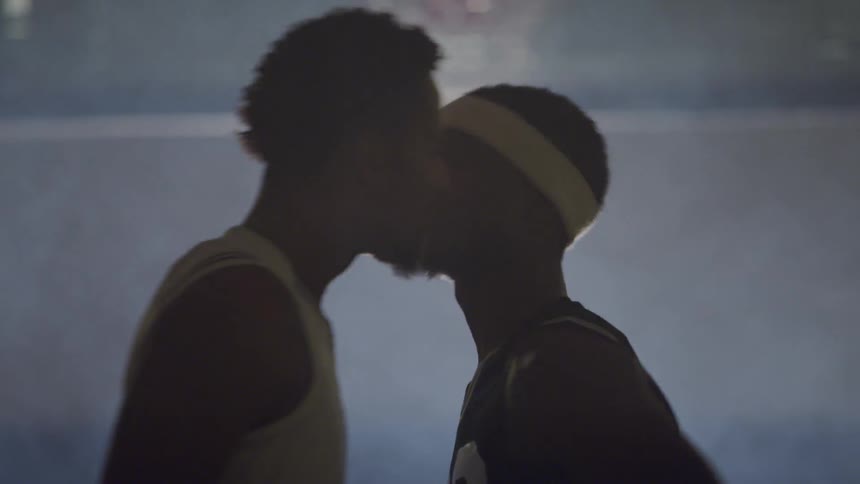 Two men push each other while on a basketball court