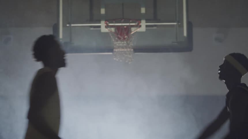 Basketball players fighting each other on the court