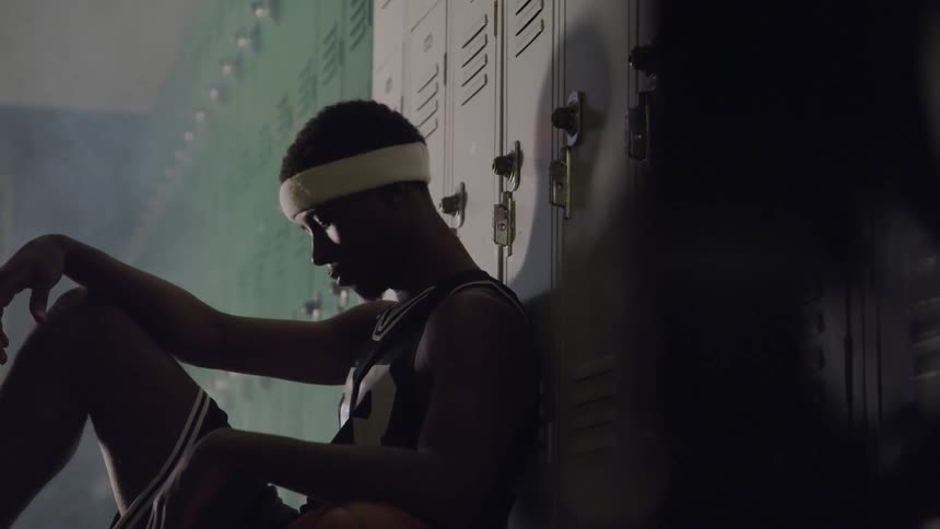 A portrait of a black young man basketball player