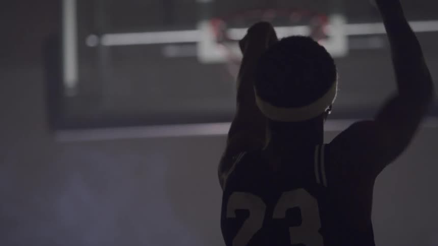 A black man doing a basketball shoot