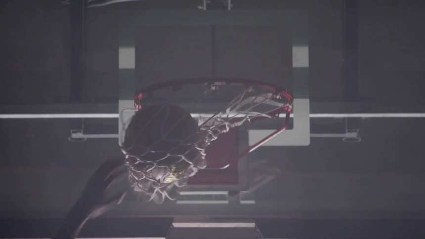 Black man shoots a basket in the basketball court