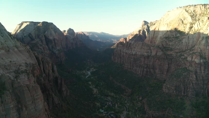 An aerial scenery of river between a huge cliff
