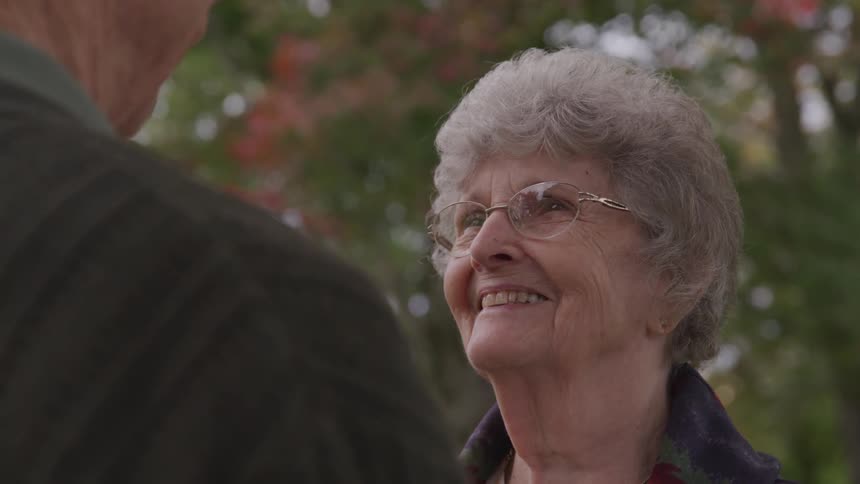 Old woman and man look at each other in the public park