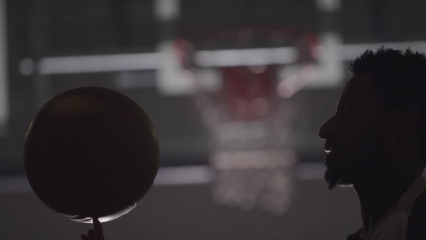 A man playing basketball on the stadium
