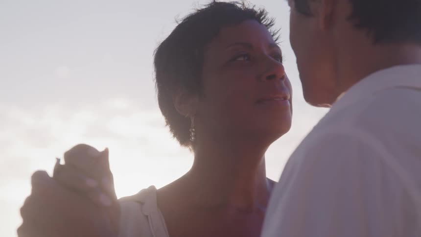 A man and woman dance outside
