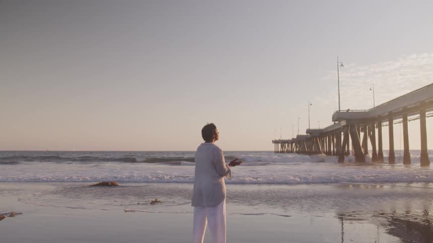 A woman doing a yoga on the beach