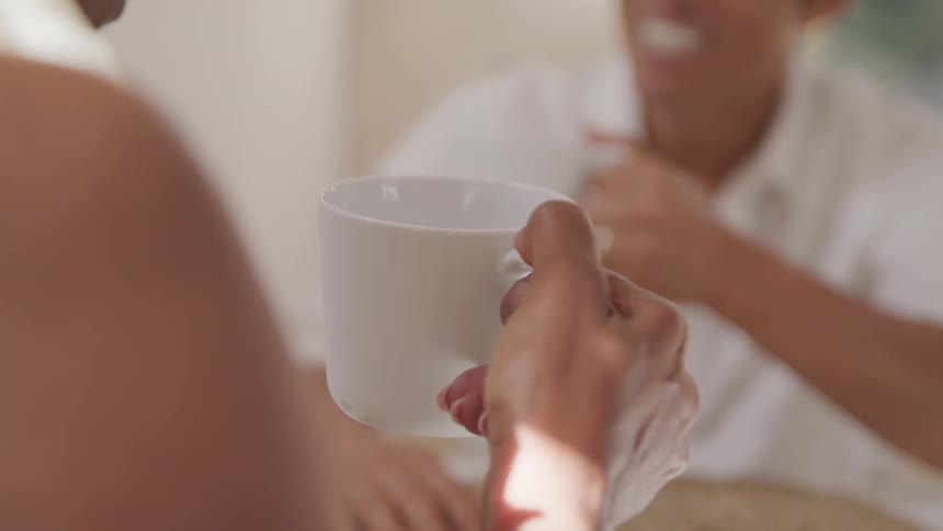 A group of people chatting while having a cup of tea