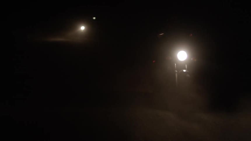 Light of a motorcycle traveling at night