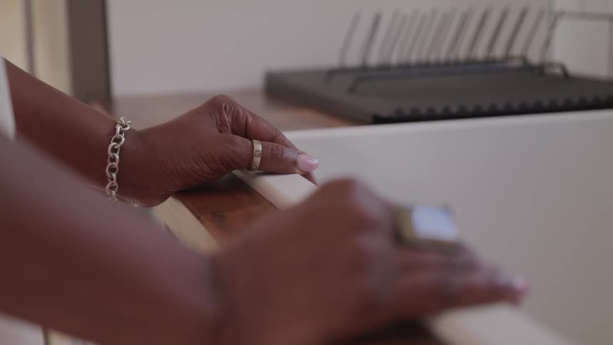 A woman hand holding a sink in the kitchen