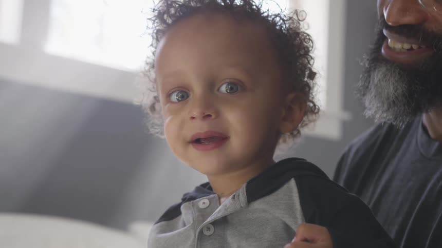 An adult holds a young child