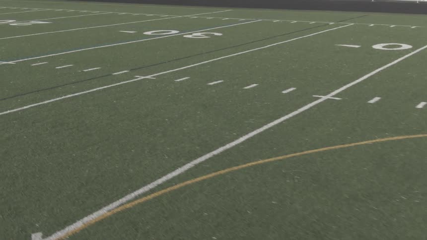 The football field is long and green