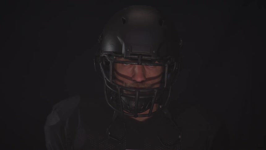 A man wearing a football helmet is displayed