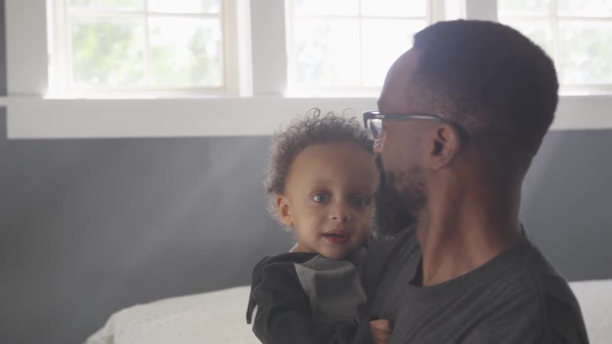 A black man taking care his son