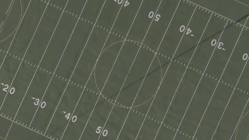 There is a yellow circle in the middle of the football field