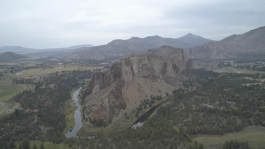 Aerial view of mountain range surrounded by river