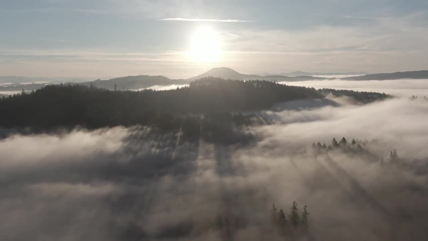 A scenery of a mountain peak above the thick cloud