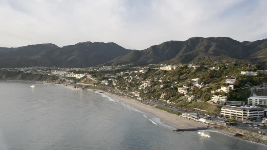 A city is nestled into the hills of a coastal area