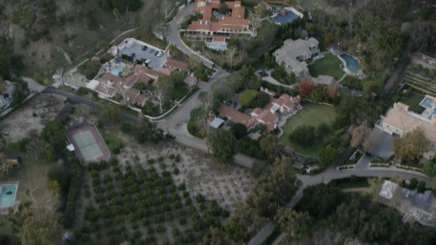 Camera flies over a bunch of houses