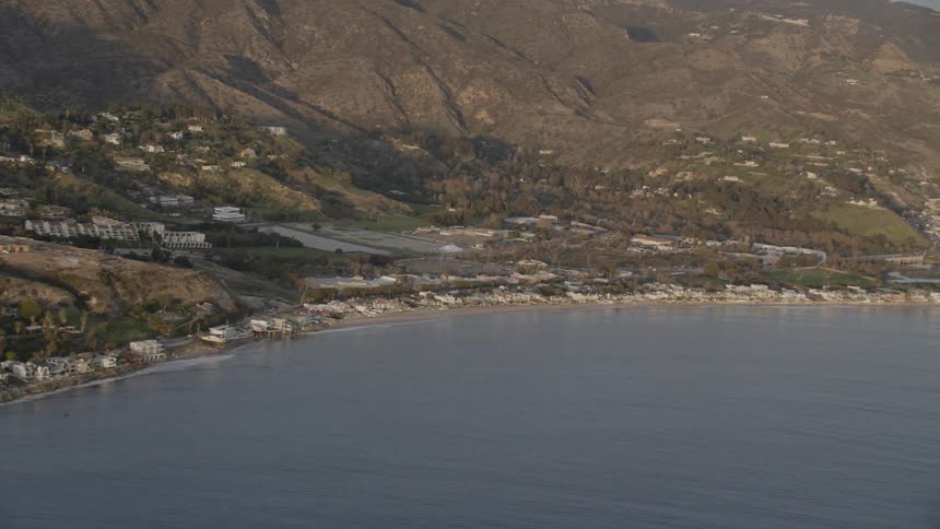 An aerial scenery of beach coastal under the mountain